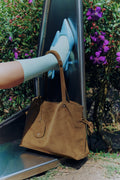 Isabelle Bag in Earth — hanging from a slide