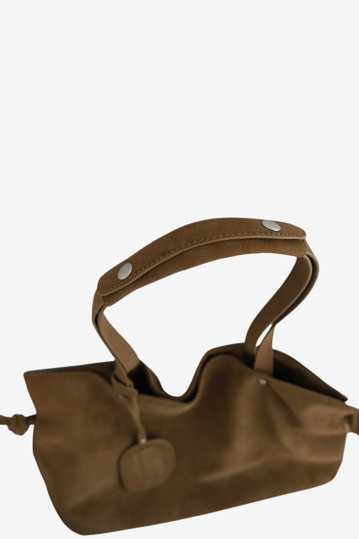 Isabelle Bag in Earth — shoulder strap detail, on light grey