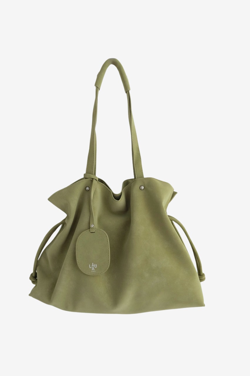 Isabelle Bag in Meadow — front with the bag charm, on light grey