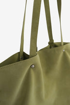 Isabelle Bag in Meadow — strap and rivet close-up, on light grey